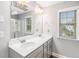Bathroom with double sinks, modern fixtures and a glass-enclosed shower at 7762 Fawn Cir, Covington, GA 30014