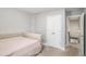 Bedroom with a tufted bedframe, carpet flooring, and closet at 7762 Fawn Cir, Covington, GA 30014