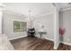 Bright dining room with hardwood floors, chandelier lighting, and a window view at 7762 Fawn Cir, Covington, GA 30014