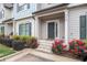 Townhouse entrance with well-maintained landscaping and rose flowerbeds leading to front door at 7762 Fawn Cir, Covington, GA 30014