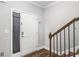 Bright entryway featuring hardwood floors, staircase, and a closet with storage at 7762 Fawn Cir, Covington, GA 30014