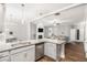 Open floorplan kitchen with stainless steel appliances, stone countertops, and hardwood floors at 7762 Fawn Cir, Covington, GA 30014