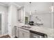 Bright kitchen with stainless steel appliances, granite counters and seamless flow into the dining space at 7762 Fawn Cir, Covington, GA 30014