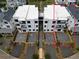 Aerial view of newly constructed townhomes with gravel driveways and modern architectural designs at 11542 Serenbe Ln, Chattahoochee Hills, GA 30268