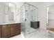 Luxurious bathroom featuring marble floors, a frameless glass shower, and a wood vanity with elegant fixtures at 11542 Serenbe Ln, Chattahoochee Hills, GA 30268