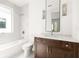 Modern bathroom featuring a marble countertop, dark wood vanity, mosaic tile wall, and decorative sconces at 11542 Serenbe Ln, Chattahoochee Hills, GA 30268