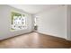 Bright bedroom with hardwood floors, large window, and views of the neighboring home at 11542 Serenbe Ln, Chattahoochee Hills, GA 30268