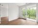Cozy bedroom with a sliding glass door to balcony and hardwood flooring at 11542 Serenbe Ln, Chattahoochee Hills, GA 30268