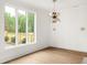 Bright dining area with large windows, hardwood floors, and modern lighting fixtures at 11542 Serenbe Ln, Chattahoochee Hills, GA 30268