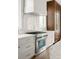 Gourmet kitchen with stainless steel oven, marble backsplash, and custom cabinets at 11542 Serenbe Ln, Chattahoochee Hills, GA 30268