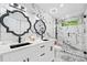 Modern bathroom with double vanity, marble tile, and glass-enclosed shower at 4439 Luther Ward Rd, Powder Springs, GA 30127