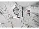 Modern bathroom featuring marble-look tile, a glass-enclosed shower, and updated vanity at 4439 Luther Ward Rd, Powder Springs, GA 30127