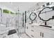 Modern bathroom with black fixtures, a glass enclosed shower, and double vanity with marble countertops at 4439 Luther Ward Rd, Powder Springs, GA 30127