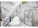 Bathroom features marble floors and walls, soaking tub, and decorative mirror at 4439 Luther Ward Rd, Powder Springs, GA 30127