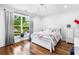 Bright bedroom with hardwood floors, large window, and a comfortable bed at 4439 Luther Ward Rd, Powder Springs, GA 30127