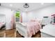 Bright bedroom featuring hardwood floors, white furniture and a decorative ceiling fan with light at 4439 Luther Ward Rd, Powder Springs, GA 30127