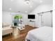 Bright bedroom with vaulted ceilings, hardwood floors, a barn door, and comfortable seating at 4439 Luther Ward Rd, Powder Springs, GA 30127