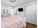 White bedroom featuring wood floors, a closet, and a television screen on the wall at 4439 Luther Ward Rd, Powder Springs, GA 30127