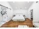 Spacious bedroom with wood floors, barn door to the bathroom, and a sitting area at 4439 Luther Ward Rd, Powder Springs, GA 30127