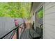 Deck with black wicker chair overlooks a fenced-in yard with mature trees at 4439 Luther Ward Rd, Powder Springs, GA 30127