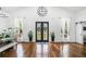 Bright entryway with high ceilings, hardwood floors, grand double doors and lovely decor at 4439 Luther Ward Rd, Powder Springs, GA 30127