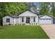 Charming home featuring board and batten siding, painted brick accents, and a well-manicured lawn at 4439 Luther Ward Rd, Powder Springs, GA 30127