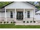 Inviting front porch with double doors, white columns, and decorative stone walkway at 4439 Luther Ward Rd, Powder Springs, GA 30127