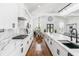 Open kitchen with quartz countertops, stainless steel appliances, and eat-in counter seating at 4439 Luther Ward Rd, Powder Springs, GA 30127