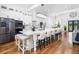 Spacious eat-in kitchen featuring a large waterfall island, stainless steel appliances, and modern lighting fixtures at 4439 Luther Ward Rd, Powder Springs, GA 30127
