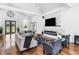 Open floor plan living room with vaulted ceilings, modern fireplace, hardwood floors and stylish decor at 4439 Luther Ward Rd, Powder Springs, GA 30127