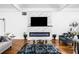 Modern living room with hardwood floors, a fireplace, comfortable seating, and neutral decor at 4439 Luther Ward Rd, Powder Springs, GA 30127