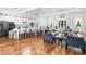 Spacious living room with open floor plan featuring modern kitchen, seating and a fireplace at 4439 Luther Ward Rd, Powder Springs, GA 30127