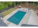 Backyard boasts a gorgeous swimming pool with a stone surround and ample lounge seating at 4439 Luther Ward Rd, Powder Springs, GA 30127