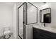 Modern bathroom featuring dark fixtures, a quartz countertop, and a glass shower enclosure at 2335 Mason Dr # D27, Atlanta, GA 30316