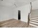 Bright bedroom featuring light wood floors, a ceiling fan, and a convenient stairwell at 2335 Mason Dr # D27, Atlanta, GA 30316