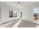 Bright bedroom featuring a ceiling fan and windows offering views of the neighborhood at 2335 Mason Dr # D27, Atlanta, GA 30316