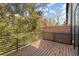 View of the wooden deck with a privacy screen, metal railing, and trees at 2335 Mason Dr # D27, Atlanta, GA 30316