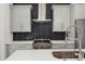 Close-up of a modern kitchen featuring stainless steel appliances and stylish black tile backsplash at 2335 Mason Dr # D27, Atlanta, GA 30316