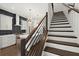 View of gourmet kitchen with modern cabinets, stainless appliances, and stylish staircase at 2335 Mason Dr # D27, Atlanta, GA 30316