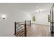 Open landing area with wood floors, modern railing, and natural light from the windows at 2335 Mason Dr # D27, Atlanta, GA 30316