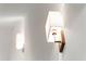 Modern sconce with a white shade mounted on a wood backing at 2335 Mason Dr # D27, Atlanta, GA 30316