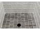 Contemporary shower floor with dark gray tiling and a modern drain at 2335 Mason Dr # D27, Atlanta, GA 30316