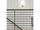 Modern staircase with metal railing and wood trim against a white paneled wall at 2335 Mason Dr # D27, Atlanta, GA 30316