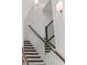 Staircase with contrasting wood steps, a dark wood banister, and modern metal railing at 2335 Mason Dr # D27, Atlanta, GA 30316