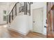 Bright foyer featuring sleek black metal stair railing, light wood floors, and a white door at 2934 Wendover St, Marietta, GA 30062