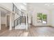 Open concept living area with high ceilings, sleek black stair railing, and light wood floors at 2934 Wendover St, Marietta, GA 30062