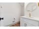 Modern powder room featuring marble countertop, gold fixtures, and a round mirror at 2934 Wendover St, Marietta, GA 30062