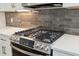 Modern stainless steel stove with marble countertops and stylish backsplash at 2934 Wendover St, Marietta, GA 30062