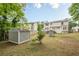 Spacious back yard features storage shed and a home with a deck above the walkout basement at 303 Cimarron Way, Lawrenceville, GA 30044