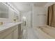 This bright bathroom has double sinks, marble floors, a soaking tub, and a separate shower at 303 Cimarron Way, Lawrenceville, GA 30044